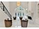 Bright, airy foyer with staircase, chandelier, fireplace, and elegant seating arrangement at 8525 Saint Marlo Fairway Way, Duluth, GA 30097