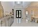 Grand foyer with gleaming tile floors, elegant double doors, and designer console table at 8525 Saint Marlo Fairway Way, Duluth, GA 30097