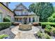 Beautiful home featuring manicured landscaping, a fountain, and classic architectural details at 8525 Saint Marlo Fairway Way, Duluth, GA 30097