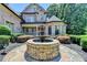 Elegant home featuring a fountain and manicured landscaping, creating a welcoming entrance at 8525 Saint Marlo Fairway Way, Duluth, GA 30097