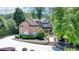 Stunning brick home featuring lush landscaping, fountain, and a circular driveway at 8525 Saint Marlo Fairway Way, Duluth, GA 30097