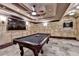 Basement game room with a pool table, dart board, and a large television, perfect for entertaining at 8525 Saint Marlo Fairway Way, Duluth, GA 30097