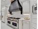 Kitchen featuring stainless steel appliances and white cabinetry, providing a modern look at 8525 Saint Marlo Fairway Way, Duluth, GA 30097