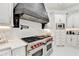 Gourmet kitchen with professional-grade appliances and custom hood vent at 8525 Saint Marlo Fairway Way, Duluth, GA 30097