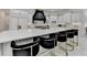 Well-lit kitchen with a large island, seating, and modern appliances for cooking and gathering at 8525 Saint Marlo Fairway Way, Duluth, GA 30097