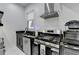 Modern kitchen featuring stainless steel appliances, granite countertop, and a window for natural light at 8525 Saint Marlo Fairway Way, Duluth, GA 30097
