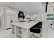 The kitchen has a marble island with chairs, stainless steel appliances, and plenty of space for cooking at 8525 Saint Marlo Fairway Way, Duluth, GA 30097