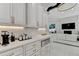 Bright kitchen with marble countertops, white cabinetry, and stainless steel appliances at 8525 Saint Marlo Fairway Way, Duluth, GA 30097