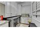 Bright laundry room with white cabinets, granite countertops, stainless steel washer and dryer, and natural light at 8525 Saint Marlo Fairway Way, Duluth, GA 30097