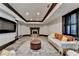 Elegant living room with fireplace, designer seating, stylish decor, and large TV for relaxing and entertaining at 8525 Saint Marlo Fairway Way, Duluth, GA 30097