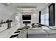 Modern living room boasts a sleek fireplace, adjacent bar area, and comfortable seating perfect for relaxation and entertainment at 8525 Saint Marlo Fairway Way, Duluth, GA 30097