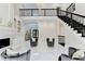 Open-concept living room with stairs, fireplace, and modern design at 8525 Saint Marlo Fairway Way, Duluth, GA 30097