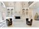 Elegant living room with fireplace, custom built-ins, and soaring ceilings at 8525 Saint Marlo Fairway Way, Duluth, GA 30097
