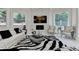 Bright living room features stone fireplace and walls of windows at 8525 Saint Marlo Fairway Way, Duluth, GA 30097