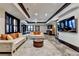 Open-concept living room with modern furniture, a ceiling fan, and a large flat-screen TV, ideal for relaxation and gatherings at 8525 Saint Marlo Fairway Way, Duluth, GA 30097
