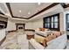 Elegant living room with a cozy fireplace, designer seating, and stylish decor creating a warm and inviting atmosphere at 8525 Saint Marlo Fairway Way, Duluth, GA 30097