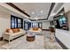 Spacious living room featuring designer sofas, a stylish coffee table, and a large TV, perfect for entertaining guests at 8525 Saint Marlo Fairway Way, Duluth, GA 30097