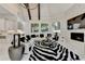 Bright living room features a fireplace, vaulted ceilings with exposed beams and black and white rug at 8525 Saint Marlo Fairway Way, Duluth, GA 30097