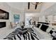 Bright living room with fireplace is open to the kitchen and staircase at 8525 Saint Marlo Fairway Way, Duluth, GA 30097