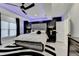 Main bedroom featuring modern lighting, a ceiling fan, and a unique accent wall at 8525 Saint Marlo Fairway Way, Duluth, GA 30097