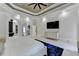 This is a spacious main bedroom with a large television and an arched doorway to the bathroom and closet at 8525 Saint Marlo Fairway Way, Duluth, GA 30097