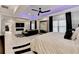 Spacious main bedroom featuring modern lighting, a fireplace, and a sitting area with a large mirror at 8525 Saint Marlo Fairway Way, Duluth, GA 30097