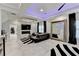 Spacious main bedroom featuring modern lighting, a fireplace, and a sitting area with a large mirror at 8525 Saint Marlo Fairway Way, Duluth, GA 30097