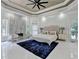 Spacious main bedroom features a tray ceiling, marble fireplace, sitting area, and large windows at 8525 Saint Marlo Fairway Way, Duluth, GA 30097