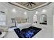 Spacious main bedroom features a tray ceiling, a mirror, access to the bathroom, and large windows at 8525 Saint Marlo Fairway Way, Duluth, GA 30097