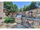 Built-in stainless steel grill with stone countertop, perfect for outdoor cooking at 8525 Saint Marlo Fairway Way, Duluth, GA 30097