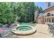 Relaxing pool and spa area with lounge chairs and a charming brick house at 8525 Saint Marlo Fairway Way, Duluth, GA 30097