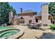 Stunning backyard with pool, spa, outdoor seating, and brick home architecture at 8525 Saint Marlo Fairway Way, Duluth, GA 30097