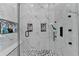 This modern shower has mosaic floors, marble walls, a bench, built in shelves, and black hardware at 8525 Saint Marlo Fairway Way, Duluth, GA 30097