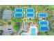 Aerial view of multiple community tennis courts surrounded by lush trees at 8525 Saint Marlo Fairway Way, Duluth, GA 30097