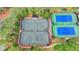 Community tennis courts surrounded by lush trees at 8525 Saint Marlo Fairway Way, Duluth, GA 30097