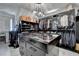 Luxurious walk-in closet featuring custom shelving, a display cabinet, and unique globe lighting at 8525 Saint Marlo Fairway Way, Duluth, GA 30097