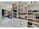 This large walk-in closet has shelves for shoes, purses, and accessories at 8525 Saint Marlo Fairway Way, Duluth, GA 30097