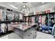Spacious walk-in closet with custom shelving, hanging racks, display island and cabinets for storing personal items at 8525 Saint Marlo Fairway Way, Duluth, GA 30097