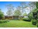 Lush backyard featuring mature trees, a screened porch, and a well-maintained lawn, ideal for outdoor enjoyment at 890 Oriole Se Ln, Marietta, GA 30067