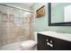 Updated bathroom featuring a tiled shower with glass doors and a modern vanity with stylish hardware at 890 Oriole Se Ln, Marietta, GA 30067