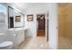 Bright bathroom with a vanity, large mirror, and access to the walk-in closet at 890 Oriole Se Ln, Marietta, GA 30067