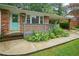 Charming brick home featuring a welcoming front porch and a delightful, light blue entry door at 890 Oriole Se Ln, Marietta, GA 30067