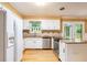 Well-lit kitchen featuring stainless steel appliances, granite counters, hardwood floors and ample cabinet space at 890 Oriole Se Ln, Marietta, GA 30067