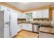 Bright kitchen featuring granite countertops, white cabinetry and stainless steel appliances at 890 Oriole Se Ln, Marietta, GA 30067
