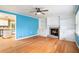 Bright living room with fireplace, built-in shelving, and hardwood floors, leading to kitchen at 890 Oriole Se Ln, Marietta, GA 30067
