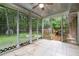 Relaxing screened porch with tile floors, ceiling fan, and views of the private backyard at 890 Oriole Se Ln, Marietta, GA 30067