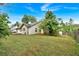 Backyard with deck, green grass and tree surround the home at 3035 Landington Way, Duluth, GA 30096