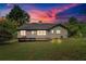 Home's serene backyard with a wooden deck, lush green lawn and mature trees for privacy at 3035 Landington Way, Duluth, GA 30096