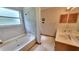 Bright bathroom featuring a double vanity, soaking tub, and tiled shower at 3035 Landington Way, Duluth, GA 30096