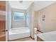 Bathroom with tub and shower combination and a large window for natural light at 3035 Landington Way, Duluth, GA 30096